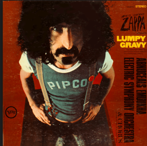 Zappa in an obscure company softball company shirt, with the ink somewhat washed off.