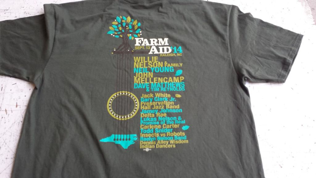 The shirt of the 2014 Farm Aid Logo Shirt uses the same elements as the poster but it specifically for the shirt design.