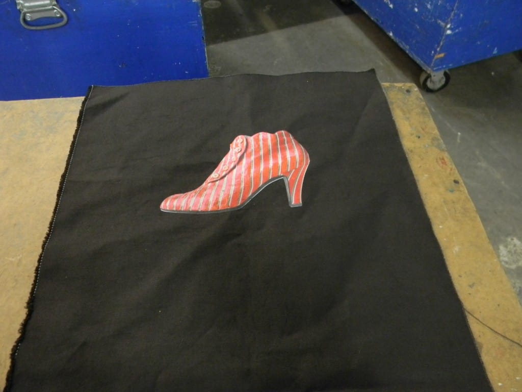 Another example of canvas printed before assembling the bag. In this case we printed 300 shirts and 300 bags and they could be printed at the same time. With a finished bag you would have to take the screens down and turn them around since  a shirt loads on the machine from the bottom and a bag loads from the top. 