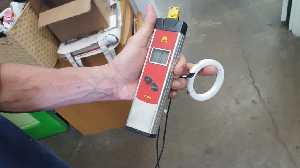 "Donut probe" or thermocouple. Gives you some idea of temperature of your ink film as it passes through the dryer, also  for measuring what is going on inside your dryer like uneven temperatures. Many folks that I respect consider this absolutely essential in your shop.